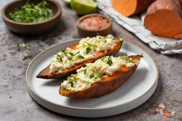Baked sweet potatoes with ricotta and fresh herbs. Healthy and vegan food
