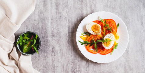 Tomato slices, egg, cheese and herbs on a plate on the table top view web banner