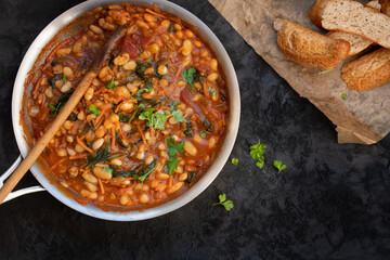 Vegan bean, tomato and carrot stew served with bread