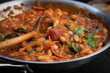 Vegan bean, tomato and carrot stew served with bread