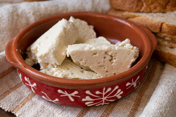 Feta cheese in clay serving dish