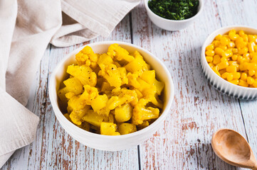 Appetizing stewed cauliflower with potatoes in a bowl on the table
