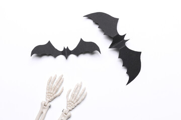 Bats and skeleton hands on white background. Halloween background