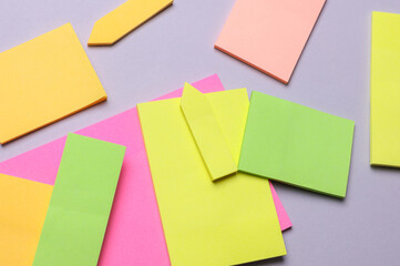 Various blank paper multicolored stickers. Sticky note collection on gray background