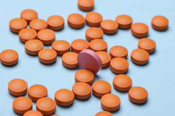 Many Orange pills on a blue background