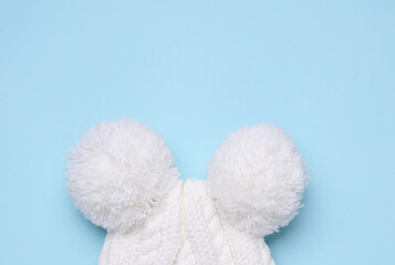 Children's warm hat with a balabons on a blue background