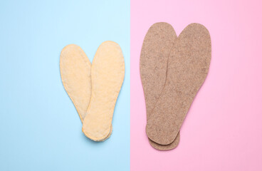 Men's and women's warm insoles in blue pink background