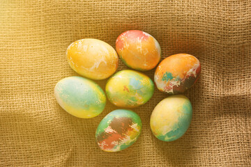 Multicolored Easter eggs on burlap. Top view