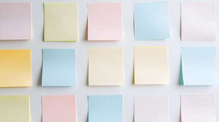 Organized sticky notes grid on white wall office space visual content minimalist environment overhead view creative organization