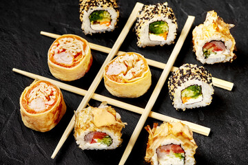 Sushi rolls forming a tic-tac-toe game on a black background