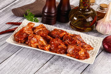 Raw marinated buffalo chicken wings