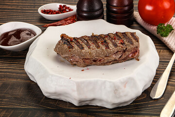 Grilled beef striploin steak with sauce