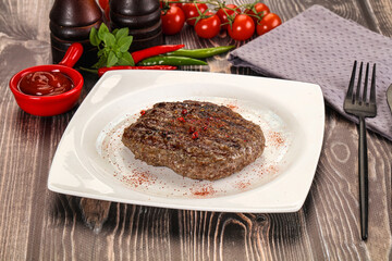 Grilled beef burger cutlet with sauce