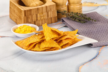 Corn nachos chips with cheese dip