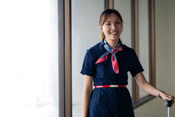 Portrait female Cabin crew or air hostess in airport. Cabin crew, air hostess working in airplane....