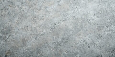 Fototapeta premium A close-up shot of a rough, textured concrete surface with a slight gray color, showing fine cracks and an uneven, gritty surface.