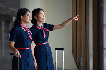 Portrait two Cabin crew or air hostess in airport. Cabin crew, air hostess working in airplane....