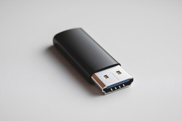 A sleek black USB flash drive with a silver USB-C connector rests on a white surface.