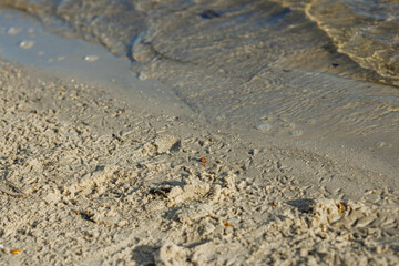 Scenic view of the Dnipro River in Kyiv with soft waves, wet sand, and clear blue water