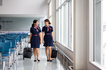 Walking in airport. Cabin crew, air hostess working in airplane. Service mind. Asian stewardess...
