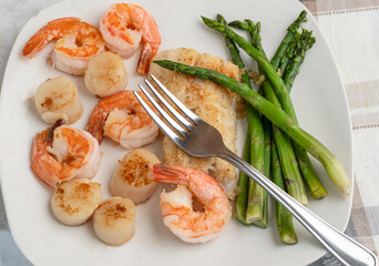 baked haddock with  asparagus  shrimp and scallops