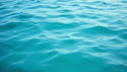 Obraz premium Calm turquoise ocean water surface under sunlight.