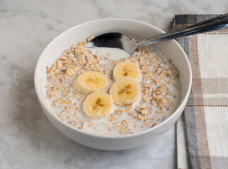 bowl of oatmeal  top with bananas
