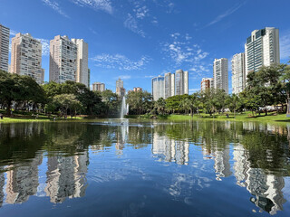 Wonderful view of Flamboyant Park with lake, tropical nature and modern buildings in Goiania, Goias, Brazil 