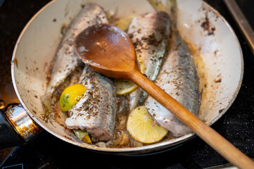 Grilled dorado fish in a frying pan. Delicious golden-brown sea bream cooked to perfection, served hot and crispy, ideal for food, seafood, and culinary-themed content.