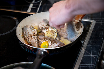 Grilled dorado fish in a frying pan. Delicious golden-brown sea bream cooked to perfection, served hot and crispy, ideal for food, seafood, and culinary-themed content.