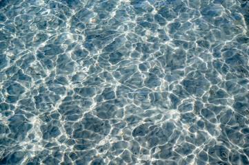 Reflections of light rays on the bottom of the pool. refracting of rays in water.