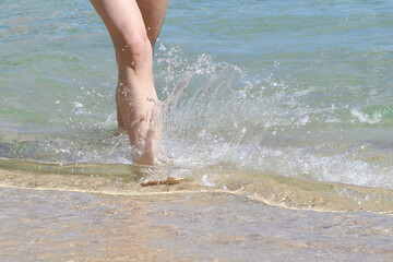 Woman's legs in surf