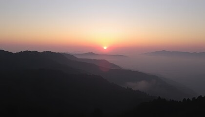 Obraz premium Sunrise Over Misty Mountain Range