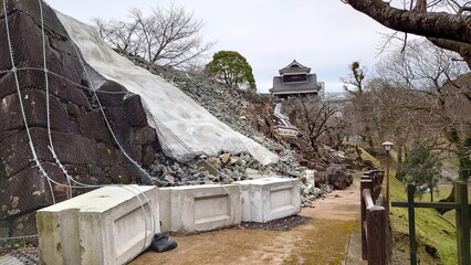 Kumamoto Castle undergoing reconstruction after earthquake damage, fortified walls and debris