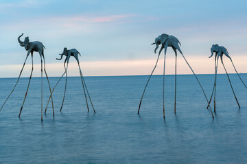 Sea and sky with an elephant sculpture.