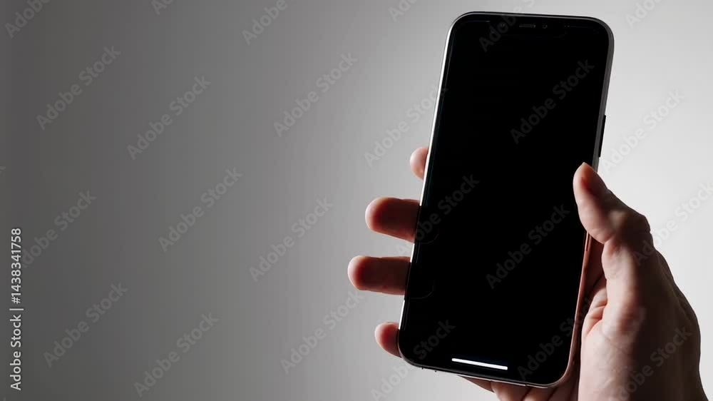 Poster Online shopping transaction occurring through smartphone, displaying purchasing process with shopping cart icon vanishing and screen fading to black against minimalist gray background