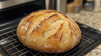 Gordijnen A close-up of a freshly baked loaf of sourdough bread with a crispy crust and soft interior, homemade baking joy © nanskyblack