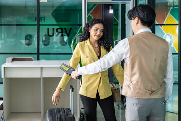 Airline ground staff is using metal scanner for security check every passenger in the airport...