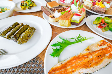 various food on plates on the table, side view, selective focus