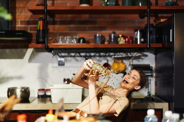 Woman holding jar of food in kitchen standing in front of stove cooking delicious meal