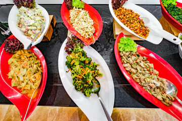 various salads on buffet table