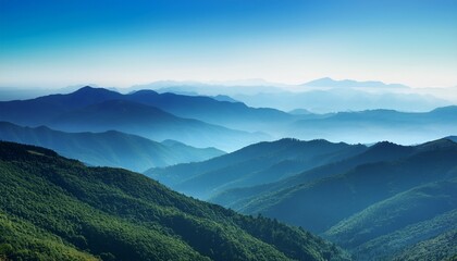 Fototapeta premium panoramic landscape with blue and green misty silhouettes of mountains and clear sky