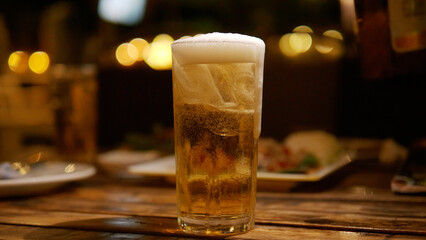 Beer glass on the table alcoholic beverage social party activity and relaxation at night golden drink