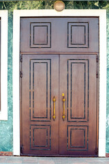 Classic tall wooden front door to the house
