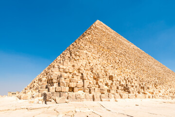A ruined corner of Egypt's majestic Cheops pyramid under the scorching sun of the Sahara Desert....
