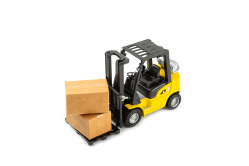 Yellow forklift isolated on white background. Logistics concept. Logistics and supply chain management for online shopping concept. Delivery of goods or products to the store worldwide. Cardboard box.