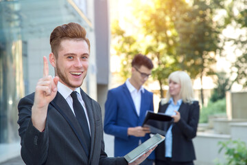 Fototapeta premium You, business man holding a digital tablet and shows finger in the direction. Employees - teamwork.