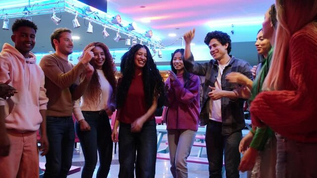 Group of friends dancing and enjoying time together at roller disco