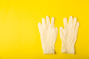 Obraz premium Medical nitrile gloves,blue cap, disposable medical mask on textured background. Medic protective clothing. Surgical latex gloves. Rubber gloves manufacturing.Medicine concept. Top view. Copy text