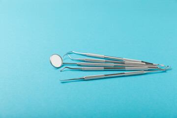 Dentist tools on a blue background. Dentist Concept.Teethcare, dental health concept. Means to care for the oral cavity. Dental model and dental equipment. Dental hygiene. Space for text. Copy space.
